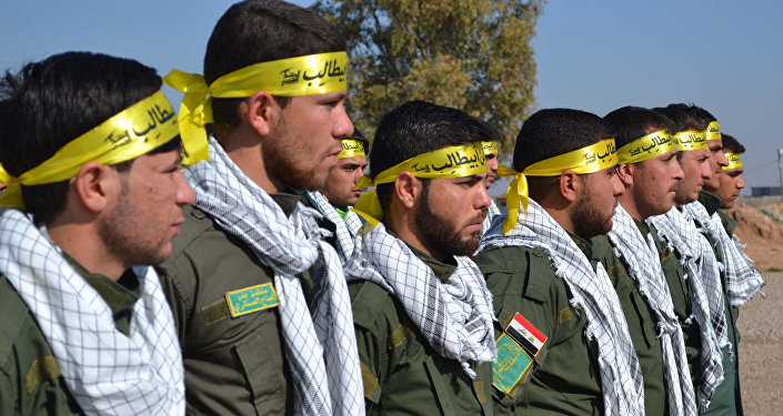 Fighters from the Iraqi Imam Ali Brigade belonging to the Badr Organisation headed by former Iraqi Transport Minister Hadi al-Amiri take part in a graduation ceremony in Taza Khurmatu 20 kms south of Kirkuk