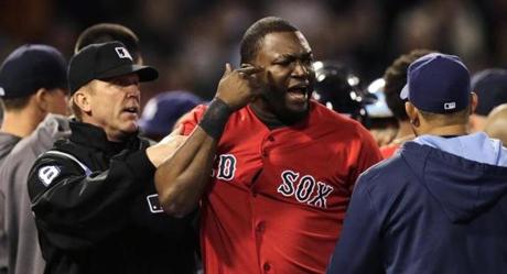 Boston Red Sox designated hitter David Ortiz is held back by umpire Jeff Kellogg after benches cleared after Tampa Bay Rays starting pitcher David Price hit Mike Carp with a pitch during the fourth inning of a baseball game at Fenway Park in Boston Frida