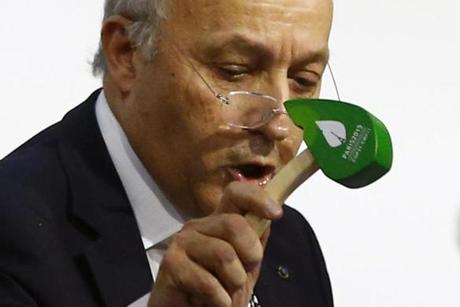 French Foreign Minister and president of the COP21 Laurent Fabius used a hammer to mark the adoption of the agreement