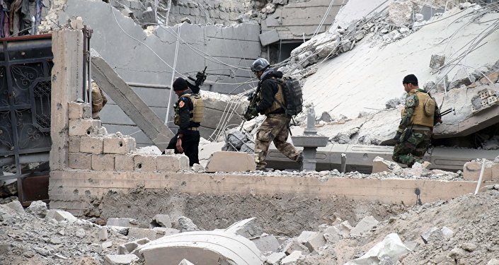 Iraqi security forces supported by U.S.-led coalition airstrikes advance their position through damaged buildings towards the central Ramadi 70 miles west of Baghdad Iraq Thursday Dec. 24 2015