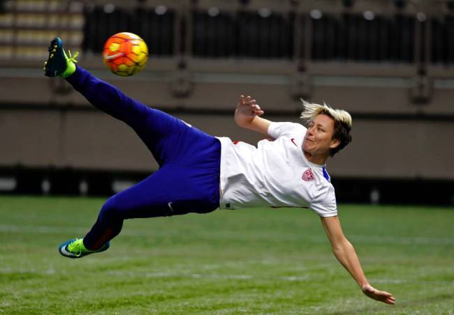 Abby Wambach left smiles during the national anthem at her final game with the U.S. team