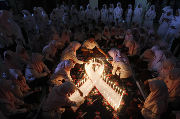 Indonesian medical students light candles during a vigil commemorating World AIDS Day in Surabaya Indonesia on Dec. 1 2015