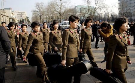 Members of the Moranbong Band from North Korea carry their instruments as they leave a hotel in central Beijing China