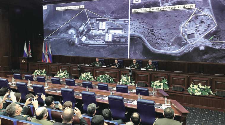 Top Russian military officials display to reporters in Moscow on Wednesday satellite images of alleged oil trucks at the Syria Turkey border