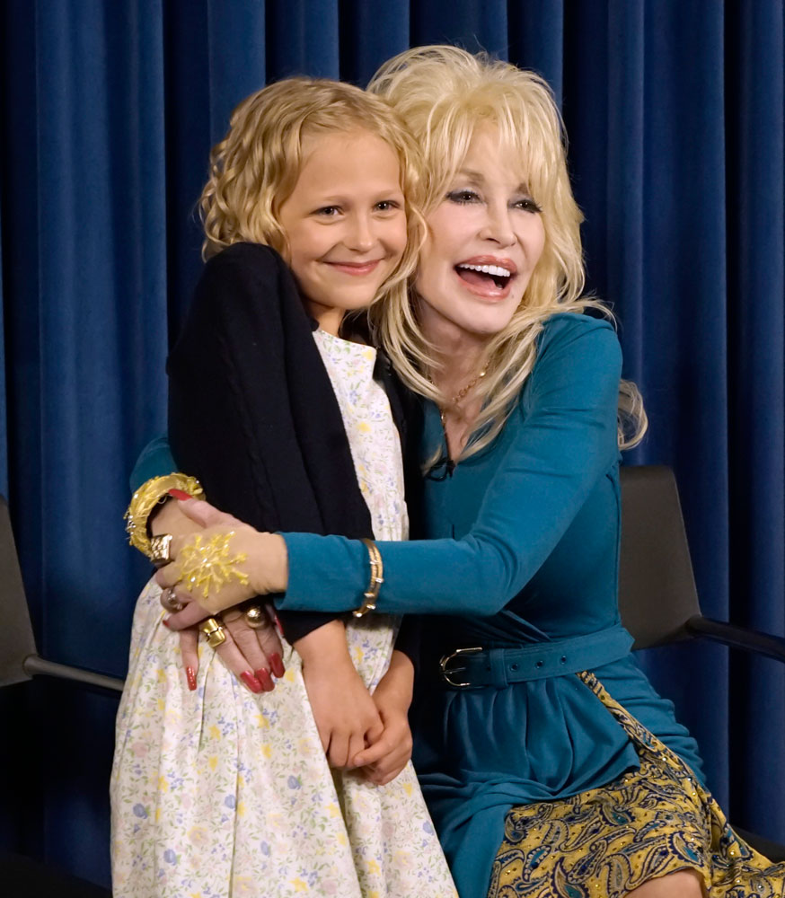 Alyvia Lind portrays little Dolly Parton. The real Dolly celebrated with her when she got the part