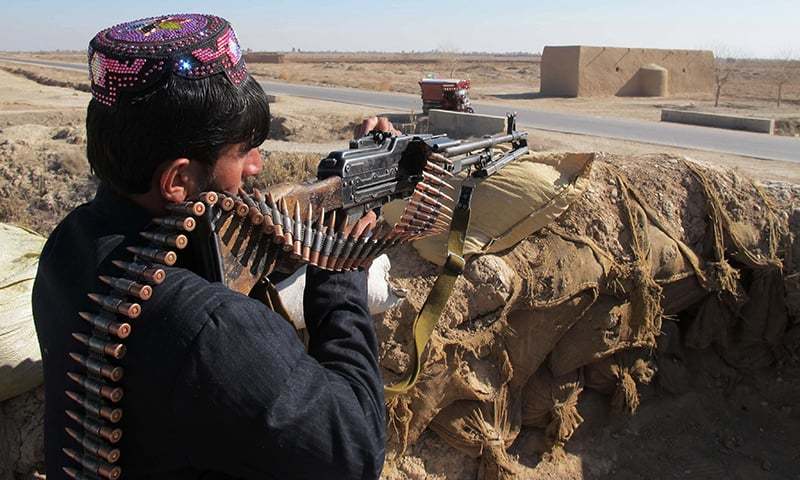 An Afghan Local Police personnel keeps watch during an ongoing battle with Taliban militants in the Marjah district of Helmand Province. ─ AFP