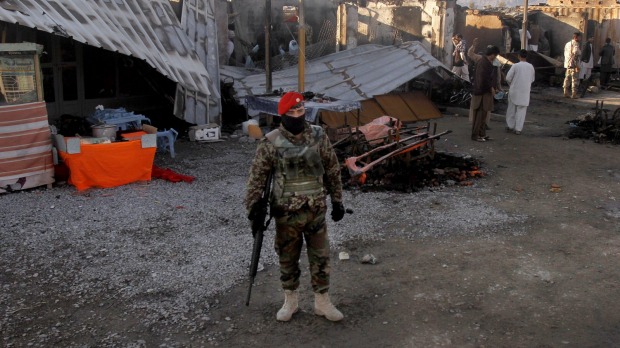 An Afghan soldier at Kandahar airport on Wednesday. stands guard after clashes between Taliban fighters