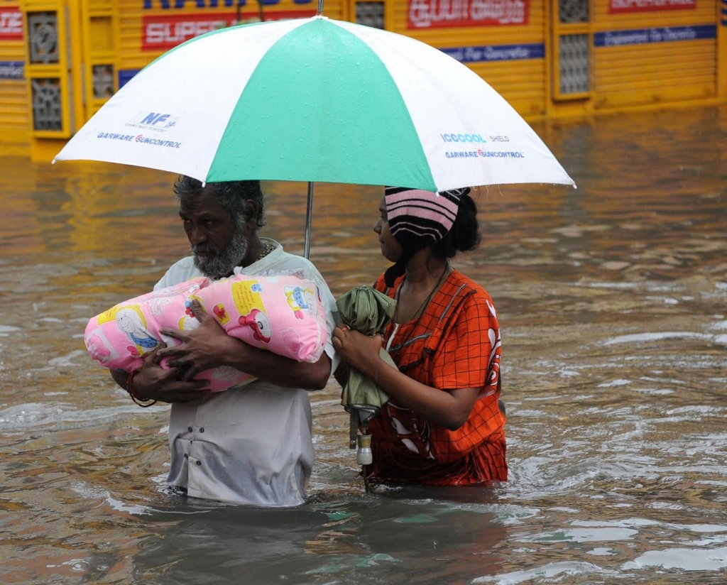 An Indian family wade through the flood waters in Chennai Getty Images