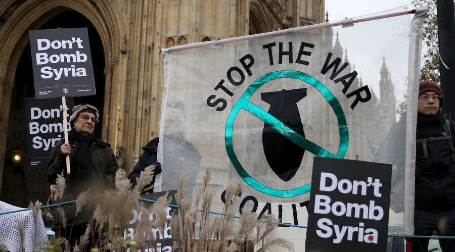 Anti-war protesters demonstrate outside the Houses of Parliament in London