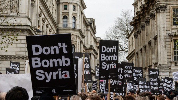 Anti-war signs crowd the skyline outside Downing Street on the weekend oppose British involvement in the bombing of Syria