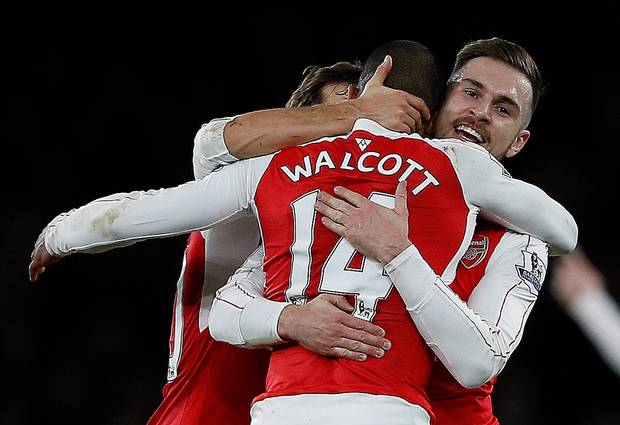 Arsenal's English midfielder Theo Walcott celebrates with Arsenal's Welsh midfielder Aaron Ramsey after scoring his team's first goal during the English Premier League football match between Arsenal and Manchester City at the Emirat