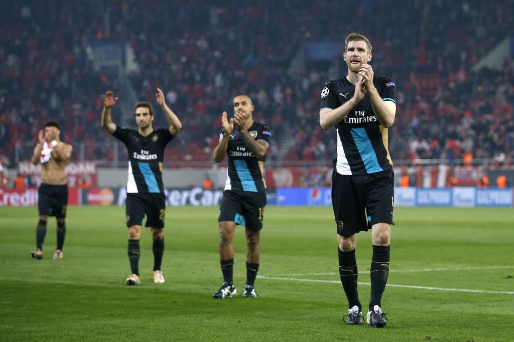 Arsenal's Per Mertesacker Theo Walcott and Mathieu Flamini celebrate at the end of the match in Greece