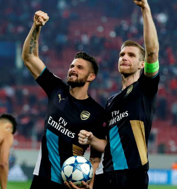 Arsenal's scorer Olivier Giroud left Per Mertesacker wave to their fans