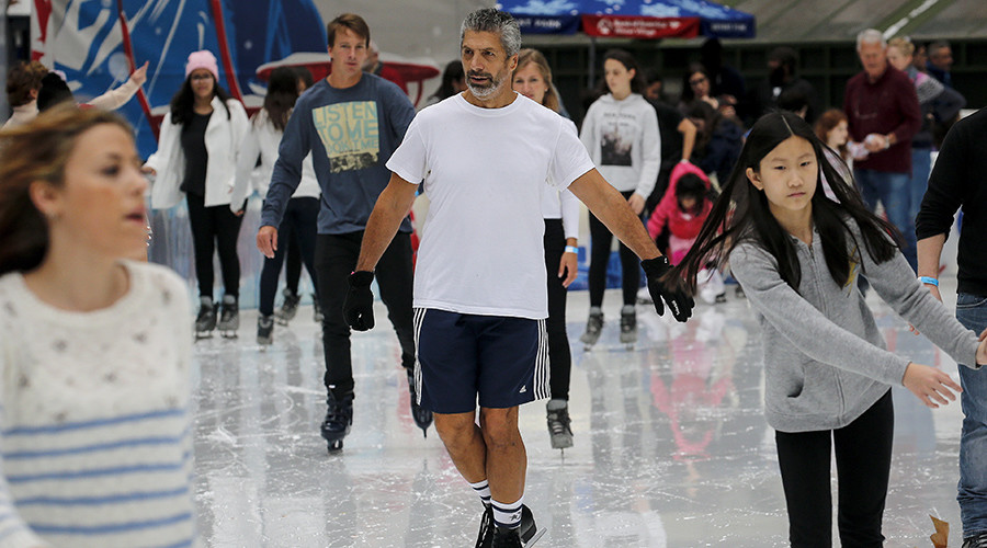 A man skates in shorts and a T-shirt at the skating rink in Bryant Park during unseasonably warm weather on Christmas Eve in the Manhattan borough of New York