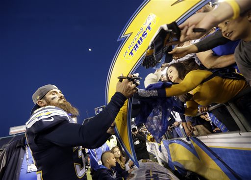 San Diego Chargers free safety Eric Weddle signs autographs after their win against the Miami Dolphins during the second half in an NFL football game Sunday Dec. 20 2015 in San Diego