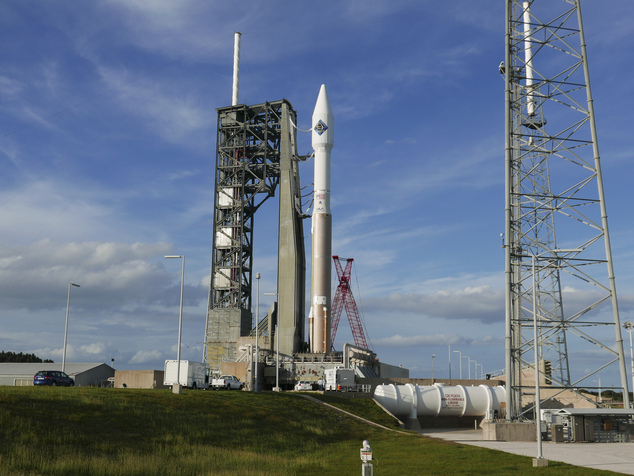 An unmanned Atlas V rocket sits on the launch pad Wednesday Dec. 2 2015 at Cape Canaveral Fla. The rocket is due to lift off early Thursday evening with