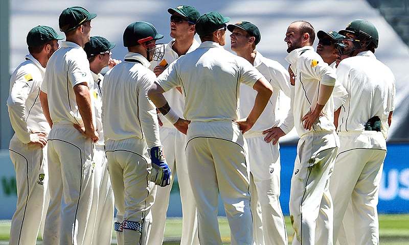 Australian spinner Nathan Lyon is congratulated by teammates after dismissing West Indies batsman Kraigg Brathwaite during the second Test in Melbourne