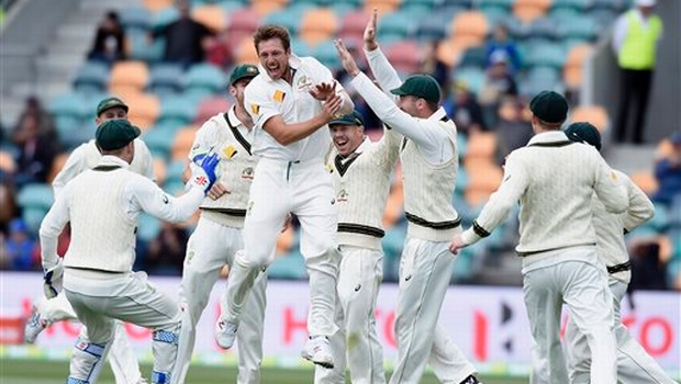 Australia's James Pattinson center celebrates with teammates after dismissing West Indies Jermaine Blackwood