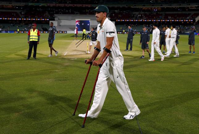 Australia's Mitchell Starc uses crutches as he walks to the presentation ceremony after the third day of the third cricket test match against New Zealand at the Adelaide Oval in South Australia