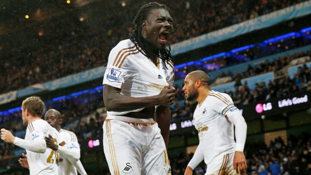 Bafetimbi Gomis of Swansea City celebrates scoring against Manchester City at Etihad Stadium on Saturday