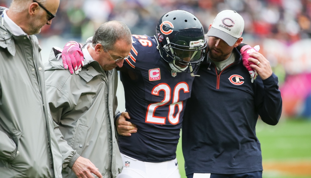 Bears safety Antrel Rolle is helped off the field after suffering an ankle injury against the Raiders