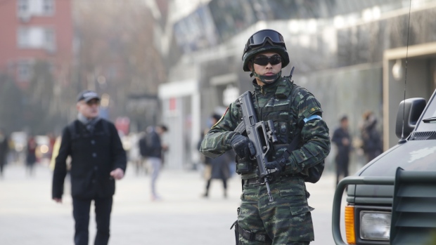 An armed policeman stands guard at the Sanlitun area in Beijing China on Thursday. Global Affairs Canada has cautioned travellers about the area after possible threats against Westerners on or around Christmas Day