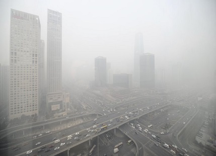 A Chinese woman wears a mask as protection as Beijing's air quality