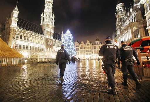 Belgian police officers patrol the Grand Place in downtown Brussels Belgium Monday Nov. 23 2015. The Belgian capital Brussels has entered its third day of lockdown with schools and underground transport shut and more than 1,000 security personnel dep