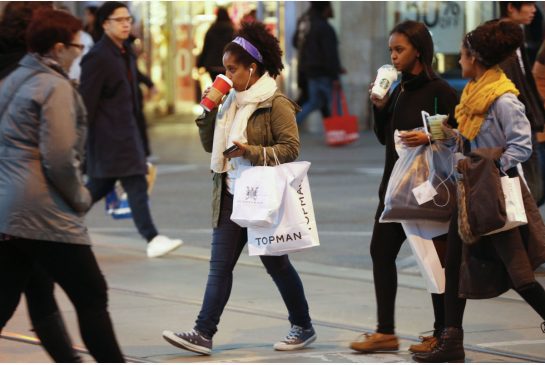 Last minute Christmas shoppers make their way from store to store in downtown Toronto on Thursday