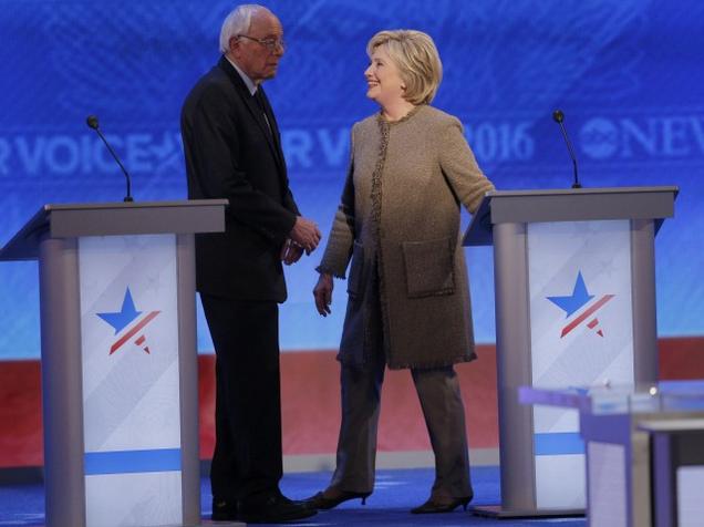 Democratic US presidential candidates Senator Bernie Sanders and former Secretary of State Hillary Clinton talk during a commercial break at the Democratic presidential candidates debate at St. Anselm College in Manchester New Hampshire