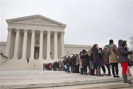 People stand in line hoping to enter the U.S. Supreme Court in Washington Wednesday to witness arguments in the Fisher v. University of Texas at Austin affirmative action case