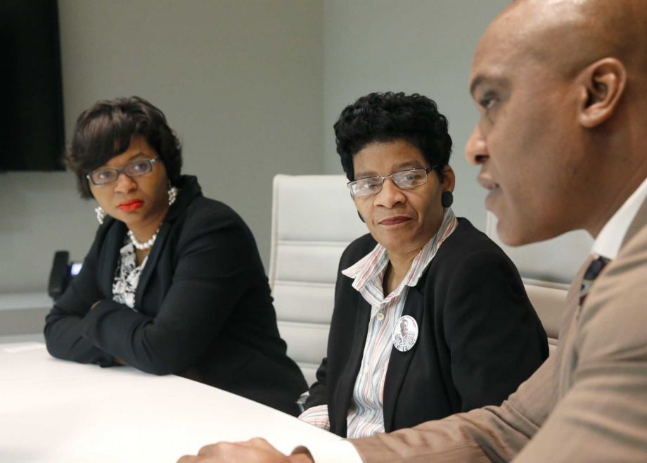 Sharon Cooper sister of Sandra Bland left and her mother Geneva Reed-Veal listen to family attorney Cannon Lambert during an interview with the Associated Press on Tuesday Dec. 22 2015 in Chicago. A Texas grand jury decided that neither sheriff's