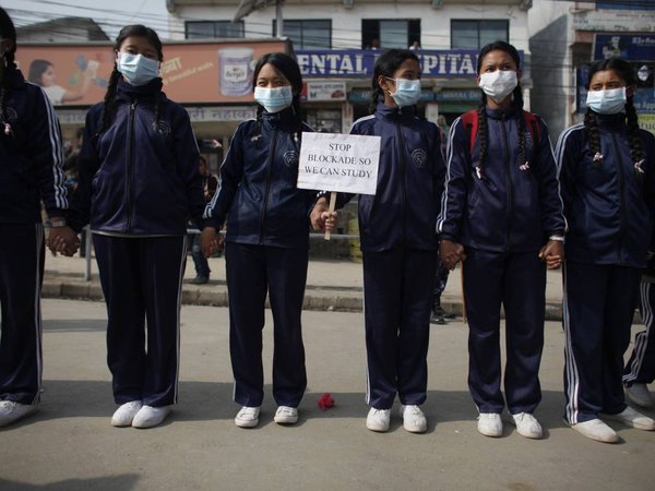 Nepalese students form a human chain during a protest against blockade in Kathmandu Nepal Friday Nov. 27 2015. Tens of thousands of students held hands waved banners and chanted slogans in Nepal´s capital Friday to protest against a border blockade