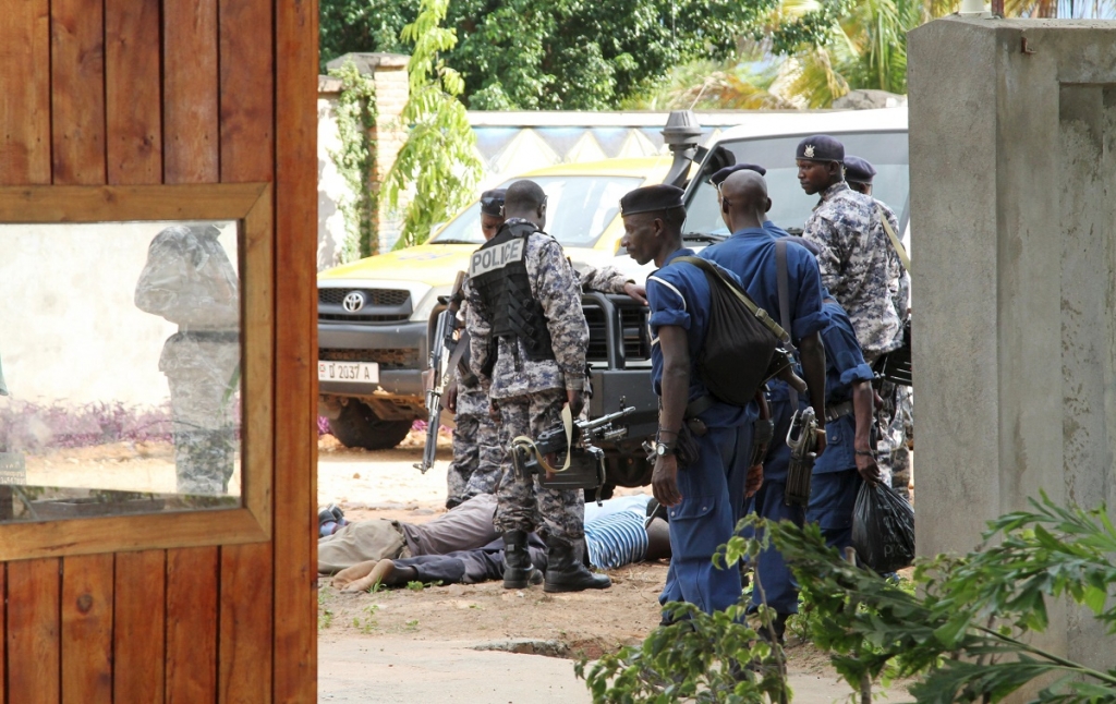 Burundian military and police frisk suspects after they recovered a cache of ammunitions recovered from combatants near Lake Tanganyika in the capital Bujumbura