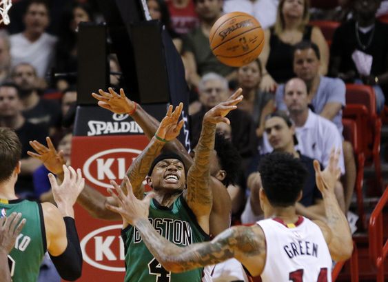 Isaiah Thomas passes from under the basket as Miami Heat guard Gerald Green defends in the first quarter of an NBA basketball game Monday Nov. 30 2015 in Miami