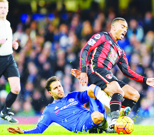 Bournemouth’s English midfielder Junior Stanislas, is tackled by Chelsea’s Spanish midfielder Cesc Fabregas during the English Premier League football match between Chelsea and Bournemouth at Stamford Bridge in London on Dec 5