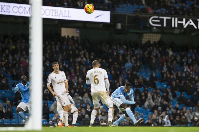 A shot from Yaya Toure left deflects into goal off the back of Kelechi Iheancho right to win the game 2-1 for Manchester City during the English Premier League soccer match between Manchester City and Swansea City at the Etihad Stadium Manchester En