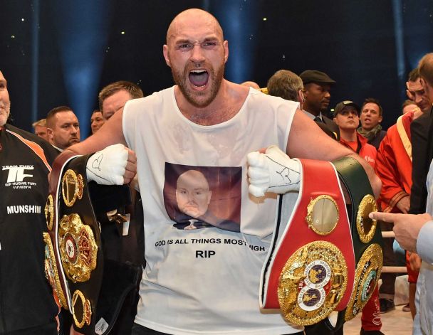 S- FILE- Britain's new world boxing champion Tyson Fury celebrates with the WBA IBF WBO and IBO belts after winning the world heavyweight title fight against Ukraine's Wladimir Klitschko in the Esprit Arena in Duessel