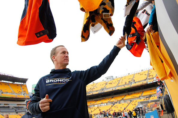 PITTSBURGH PA- DECEMBER 20 Peyton Manning #18 of the Denver Broncos signs autographs before the start of the game against the Pittsburgh Steelers at Heinz Field