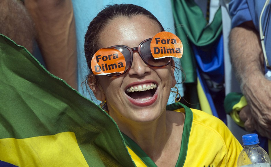 A demonstrator wears glasses that read'Dilma Out during a march demanding the impeachment of Brazil's President Dilma Rousseff