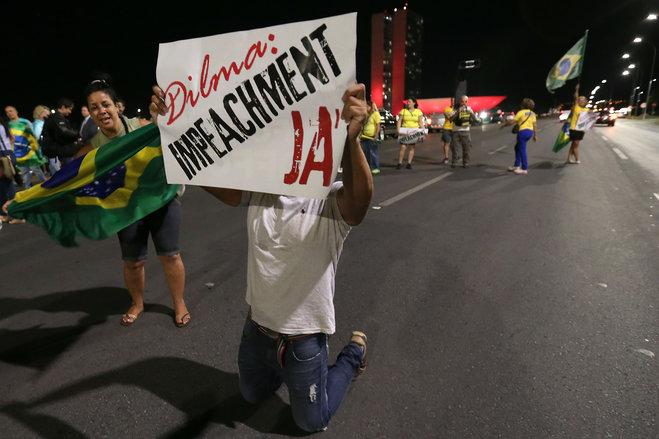 People demonstrate against the government as they take part in protest in favor of the impeachment of Brazil's President Dilma Rousseff in front of the National Congress in Brasilia Brazil Wednesday Dec. 2 2015. Impeachment proceedings were opened W