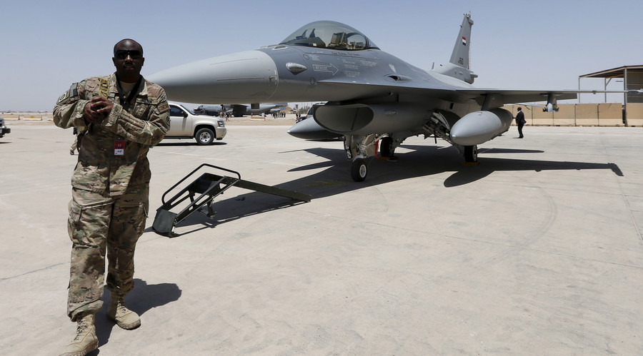 A U.S. Army soldier walks near a F-16 fighter jet during an official ceremony to receive four of these aircrafts from the U.S. at a military base in Balad Iraq