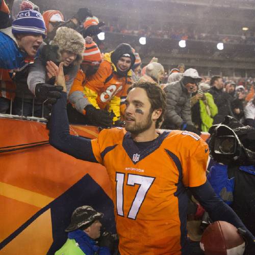 Brock Osweiler celebrates with fans after Denver's 30-24 overtime win over the Patriots Sunday