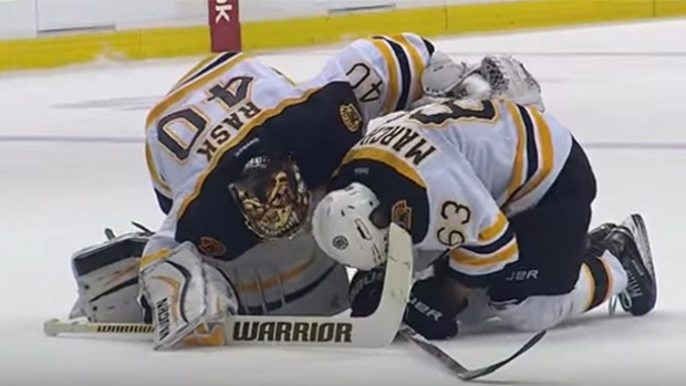 Boston Bruins forward Brad Marchand is consoled by teammate Tuukka Rask after being speared by Vancouver Canucks forward Brandon Prust on Saturday night