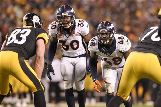 Denver Broncos strong safety David Bruton and outside linebacker Shaquil Barrett play against the Pittsburgh Steelersof an NFL football game in Pittsburgh Sunday Dec. 20 2015