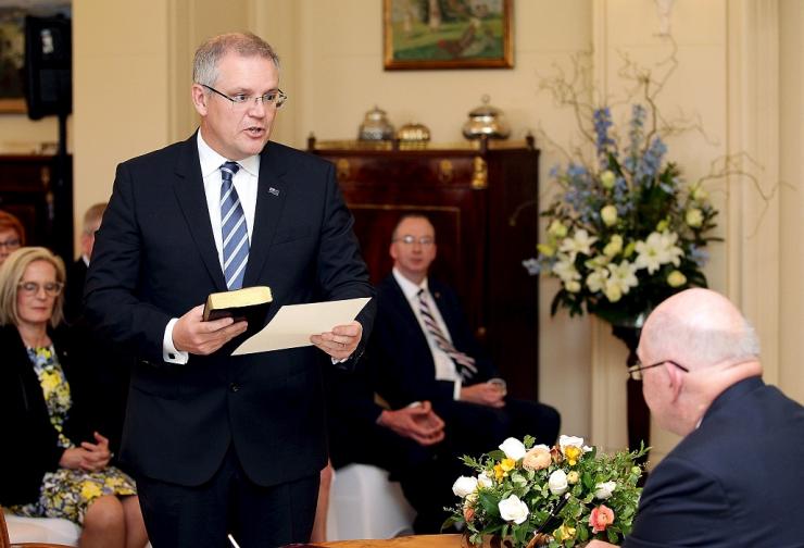 Australian Treasurer Scott Morrison participates in a swearing-in ceremony with Australian Governor General Peter Cosgrove at Government House in Canberra Australia