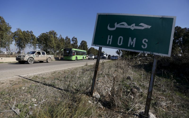 Buses leave district of Waer during a truce between the government and rebels in Homs Syria. – Reuters pic