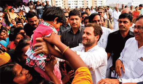 CHENNAI India’s Congress party vice president Rahul Gandhi lifts a child as he meets people affected by the floods in Chennai India yesterday. — AP