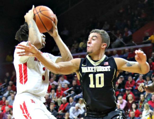 Corey Sanders of Rutgers left is defended by Mitchell Wilbekin of Wake Forest in the first half