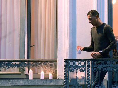 Mohamed Abdeslam places candles on a window ledge of his family's apartment Nov. 18 during a candlelight vigil in Brussels Molenbeek district town square. Two of his brothers were among the attackers in Paris on Nov. 13